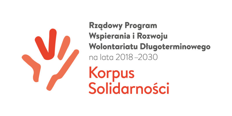 Grafika przedstawia informacje o Rządowym Programie Wspierania Rozwoju Wolontariatu Długoterminowego na lata 2018-2030. Z lewej strony schematyczny rysunek dłoni w kolorze czerwonym, z prawej strony tekst: Korpus Solidarności.